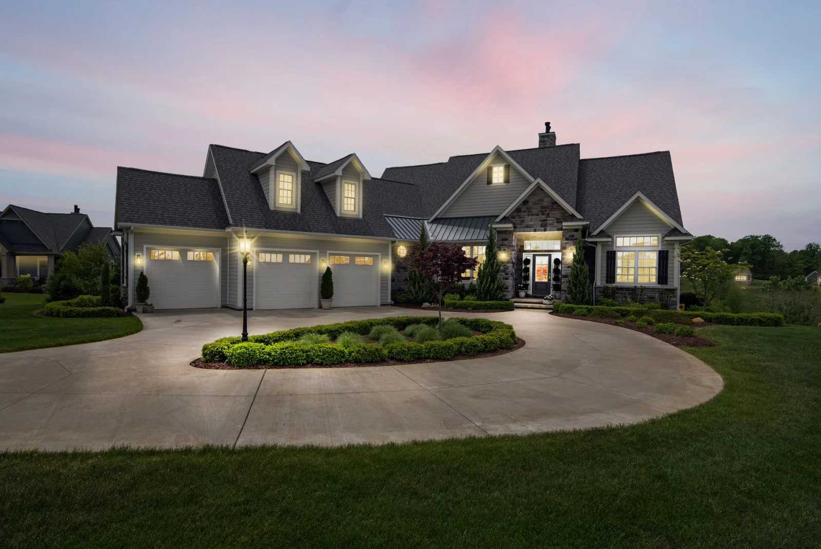 Upscale Texas home glowing with warm lighting at dusk